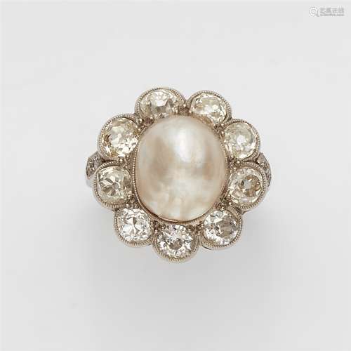 A Belle Epoque diamond and pearl ringA platinum ring with diamond set shoulders and a flower-