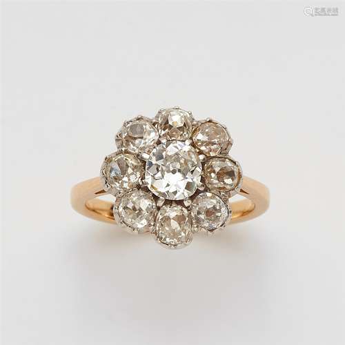 An 18k gold and diamond cluster ringThe bezel cluster set with nine cushion shaped old-cut