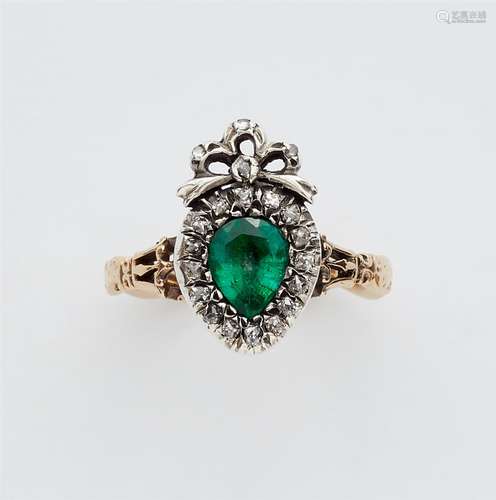 A 14k gold, emerald and diamond George III Claddagh ringA silver and 14k gold ring with a curved