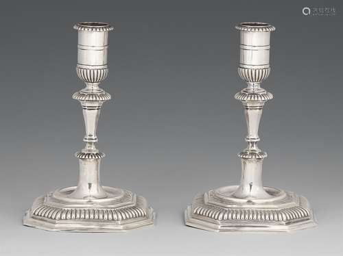 A pair of Halberstadt silver candlesticksSilver. Baluster-form shafts issuing from square