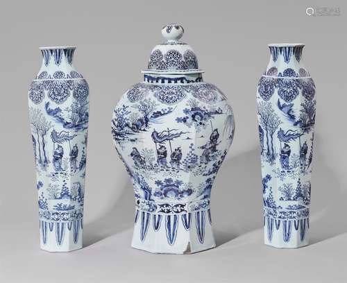 An important set of three large Delftware faience vasesComprising one covered baluster-form vase