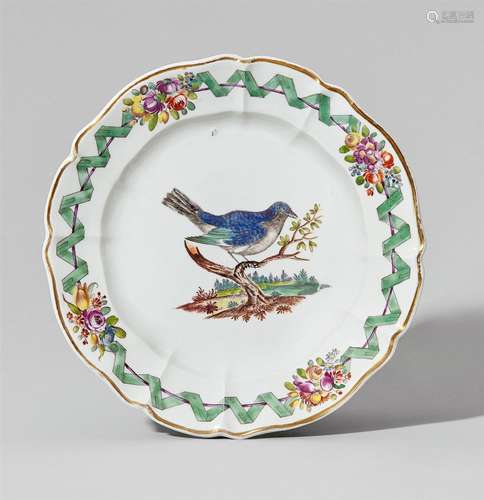 A Nymphenburg porcelain plate with birds and a green ribbonShallow plate with scalloped rim. A minor