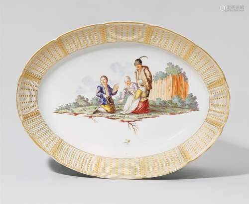 An oval Nymphenburg porcelain platter with a peasant sceneGilt-rimmed platter decorated with a scene