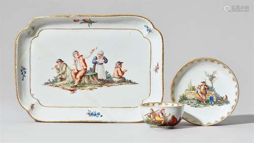 A Nymphenburg porcelain platter, cup, and saucer with peasant scenesFinely painted with rustic