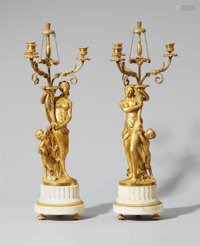 A pair of Neoclassical ormolu girandoles with nymphs and maenadsFire-gilt bronze and white marble