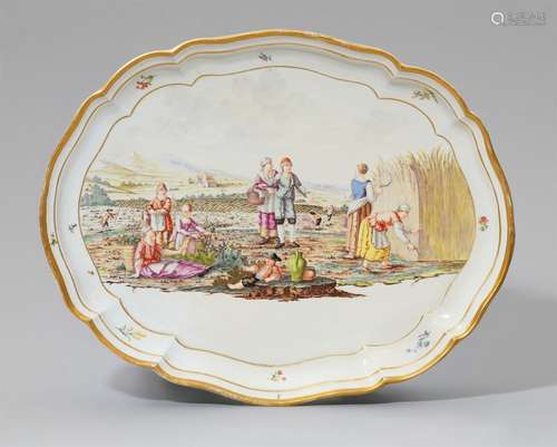 An oval Nymphenburg porcelain platter with a harvest sceneScalloped plate with moulded rim.