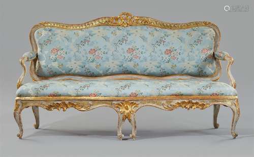 A Rococo canapéWhite and gilt softwood, replaced silk covers over upholstery. Designed to be