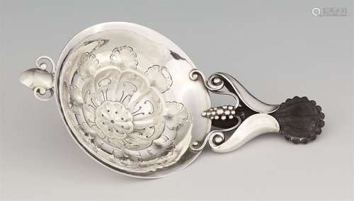 A silver tea strainer by Georg Jensen, model no. 98A funnel shaped dish with pierced foliate décor