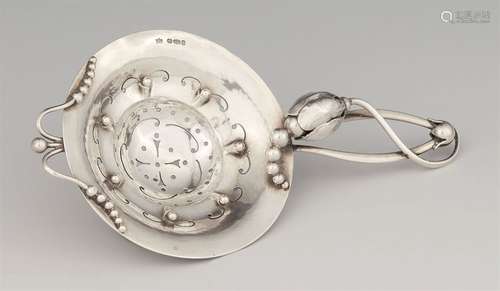 A silver tea strainer by Georg Jensen, model no. 8Magnolia model. L 15; W 7.7 cm, weight 47 g.