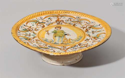 An Italian maiolica serving platterA shallow dish with a raised rim on a moulded flaring foot.