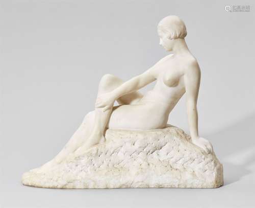 A white marble figure of a seated nudeSigned lower left 