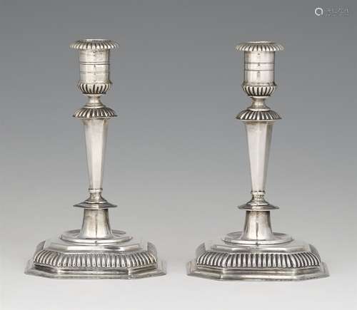 A pair of Silesian silver candlesticksTapering faceted shafts issuing from square gadrooned bases. H