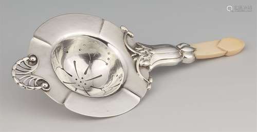 A silver tea strainer by Georg Jensen, model no. 6Semi-spherical tea strainer with a flaring rim,