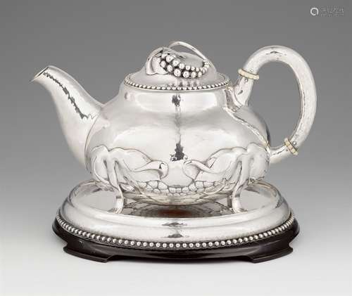 A Copenhagen silver teapot and stand by Evald NielsenThe round stand with a slightly raised rim on