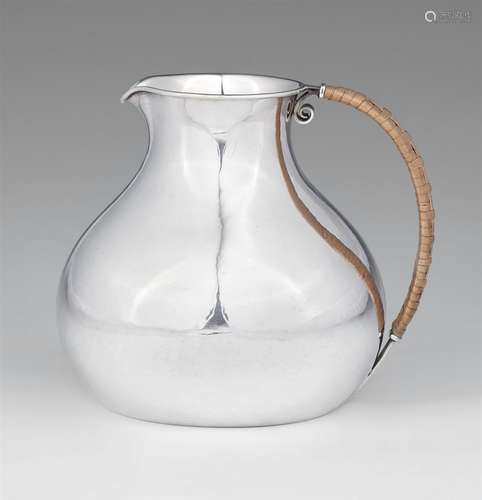 A Danish silver water jug by Hans HansenPear-form jug with wicker handle. H 11 cm, weight 320 g.