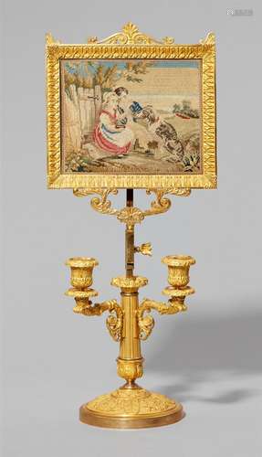 A restoration period ormolu table candlestick with a lithophane frameFire-gilt and silver plated