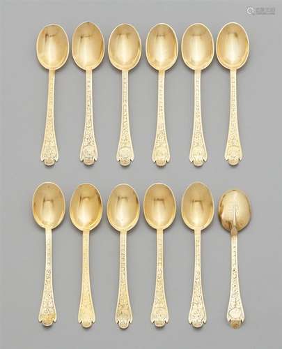 12 Baroque silver spoonsSilver-gilt spoons with oval bowls, the terminals decorated on either side