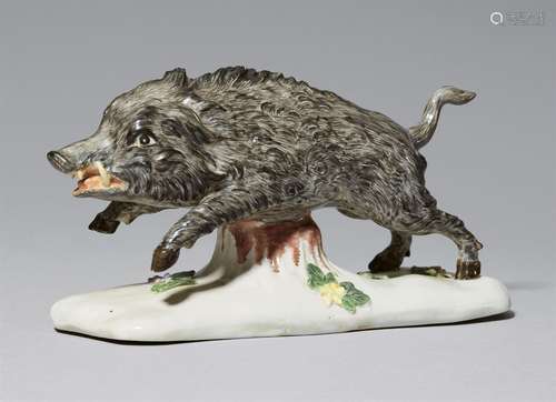 A rare Höchst porcelain figure of a running boarModel of a wild boar on an earth mound base with