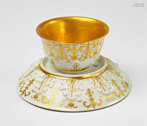 An early Meissen porcelain tea bowl with acanthus reliefThe tea bowl and original saucer with