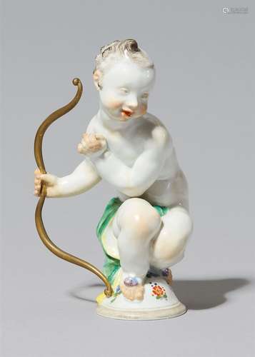 A Meissen porcelain model of CupidModel no. A 1013. With later gilding. Blue crossed swords mark