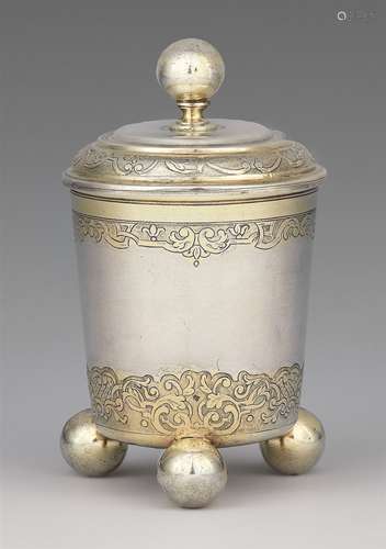 An Augsburg Règence silver beakerSilver; partly gilded. Parcel-gilt silver beaker on three spherical