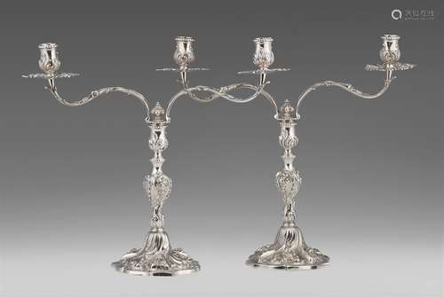 A pair of George II silver candelabraBaluster-form shafts richly decorated with roses and shellwork,