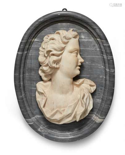 An androgynous relief bustWhite and pale marble bust of a figure with flowing locks facing right