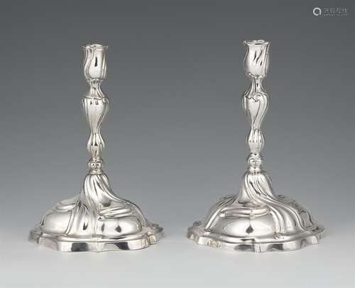 A pair of Augsburg silver candlesticksSilver Baluster-form shafts with draperies issuing from round,