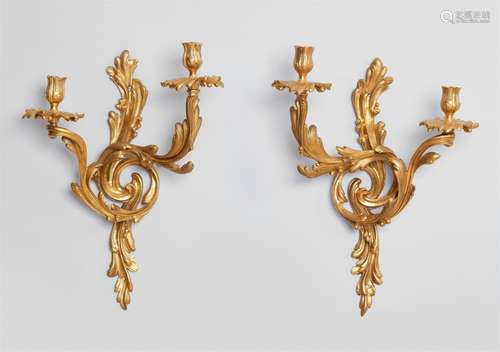 A pair of Louis XV ormolu appliquesTwo-flame fire-gilt bronze appliques cast in several pieces and