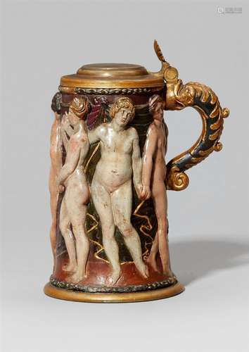 An unusual earthenware tankard with a figural reliefSlightly tapering tankard with green glazed