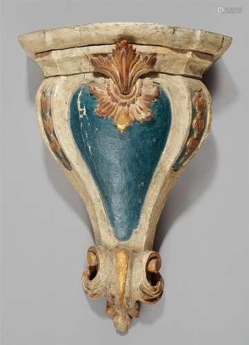 A Baroque carved wood bracketCarved wood painted blue and white and gilded. Old insect damage.