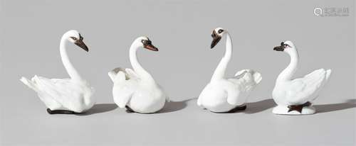 Four Meissen porcelain models of swansModels of perching swans with minimalistic polychromy in black