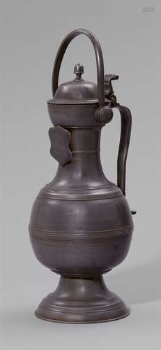 A Swiss pewter guild pitcherFinely engraved baluster-form pewter vase on a domed base. The hinged