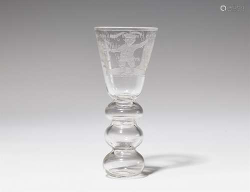 A cut glass beakerTapering cylindrical beaker with hollow shaft. The reverse engraved 