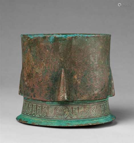 An early Islamic mortarCast and chased bronze with sintered remnants of red pigment. Originally of