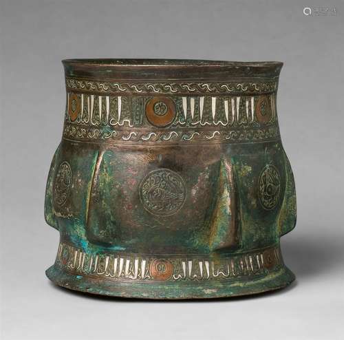 An Islamic mortar with bird motifsChased bronze with silver and copper damascening and remnants of