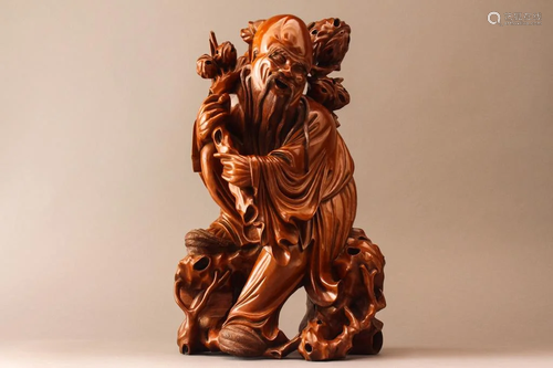 A Chinese wood figural carving of an old…