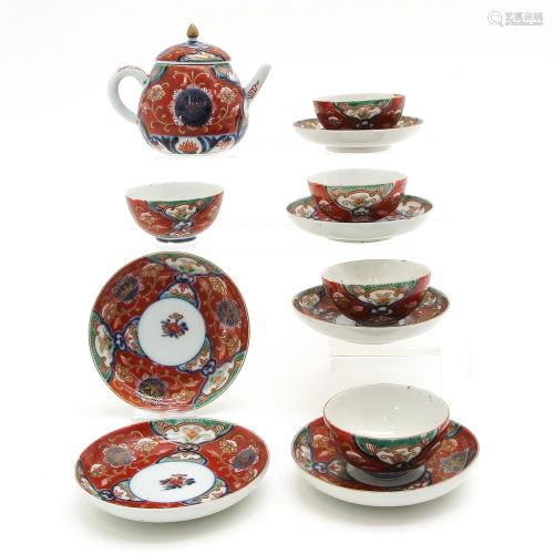 A Teapot with Cups and Saucer