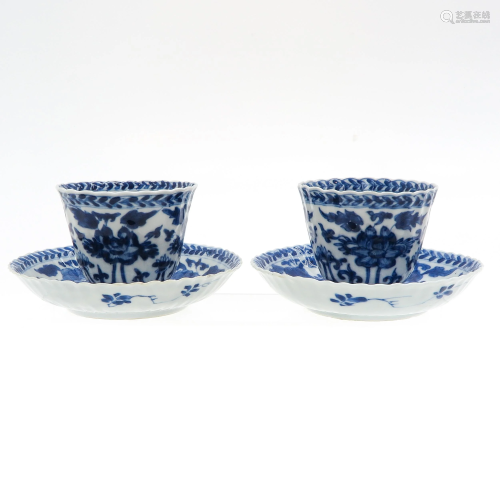 Two Blue and White Cups and Saucers
