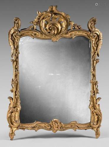 Mirror in a gilded pediment frame carved with an o…