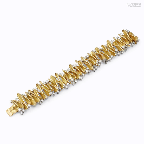 An eighteen karat gold and diamond bracel…