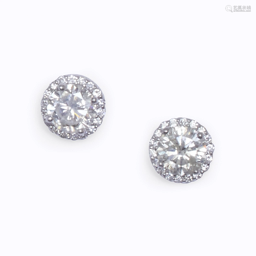 A pair of diamond and eighteen karat white …