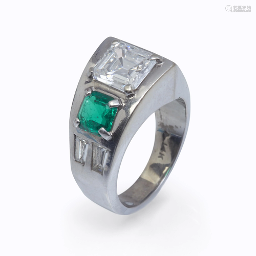 A diamond, emerald, and fourteen karat white …