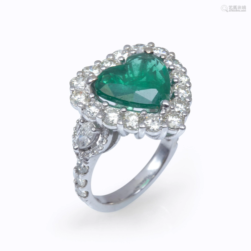 An emerald, diamond, and eighteen k…