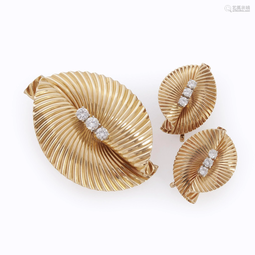 A fourteen karat gold and diamond ear cli…