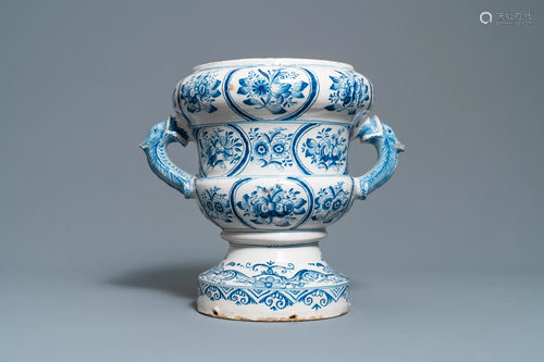 A large blue and white two-handled urn w…