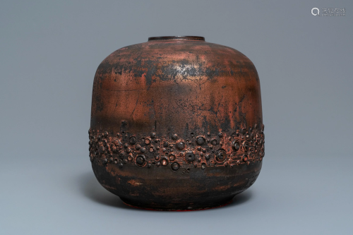 A brutalist vase with matte black and luster gl…