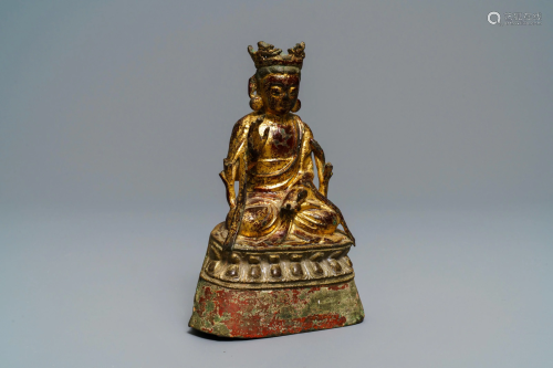 A Burmese lacquered and gilt bronze figure of …