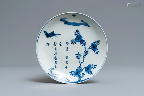 A Chinese blue and white plate with calligra…