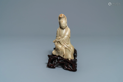 A Chinese soapstone figure of Guanyin on car…